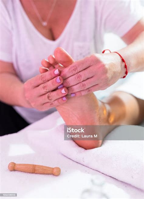 Therapist Doing Foot Reflexology With The Fingers On Acupressure Point