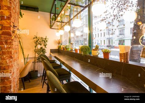 Coffee shop interior design With chairs and red bricks wall Stock Photo - Alamy