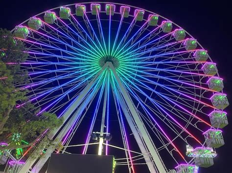 Premium Photo Illuminated Ferris Wheel At Night Colorful Giant Ferris