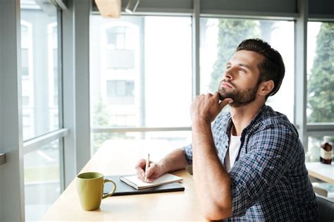 Premium Photo Thinking Man In Office Coworking While Writing Notes