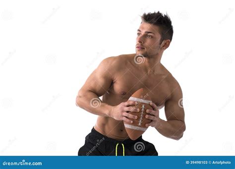 Muscular American Football Player Shirtless Ready To Throw Ball Stock