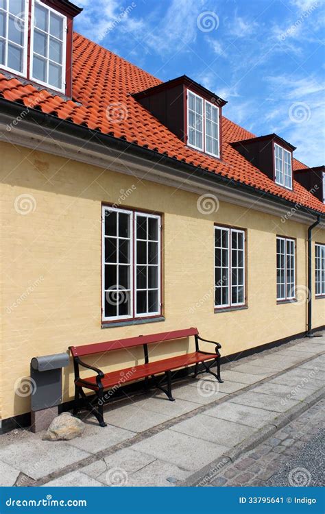 Yellow house with red roof stock image. Image of property - 33795641