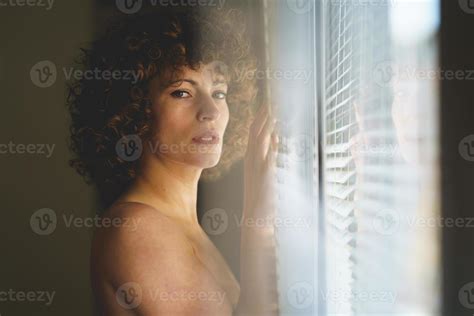 Charming Naked Woman Near Window Looking At Camera Stock Photo At Vecteezy