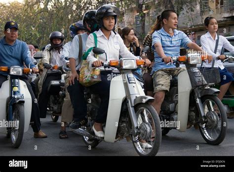 A Group Of People Are Riding Motorcycles In Heavy Traffic On A Busy