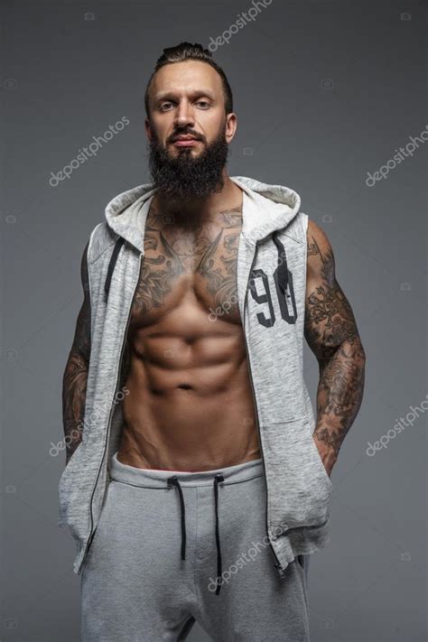 Muscular Tattooed Man With Beard Stock Photo Fxquadro