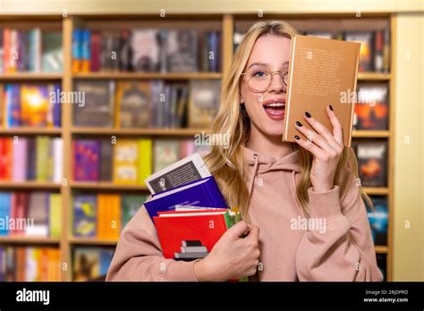 Pretty Blonde Woman Standing With Books In Library Stock Photo Alamy