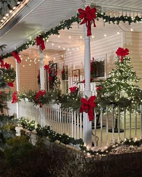 A House Decorated For Christmas With Red Bows And Lights On The Front