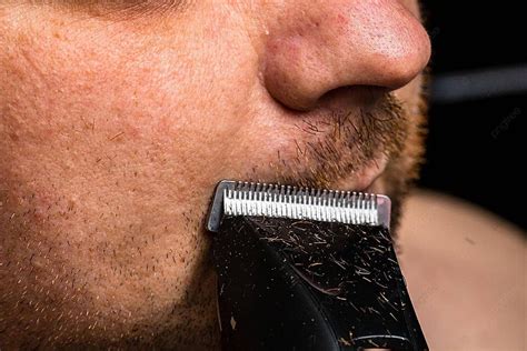 Male Grooming Using A Hair Clipper To Shape Or Trim Facial Hair Photo ...