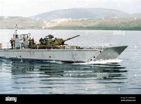 An LCM 8 Mechanized Landing Craft Transports An M 60A1 Tank Toward