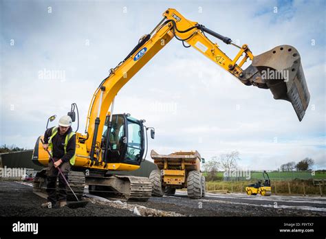 Yellow Heavy Jcb Digger Excavator Plant Machinery At Work On Preparing