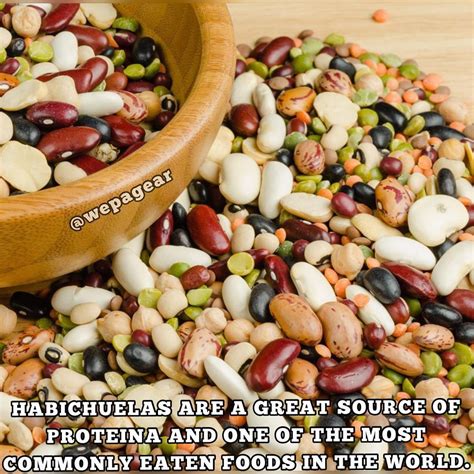 A Wooden Bowl Filled With Beans Next To A Pile Of Peanuts And Other