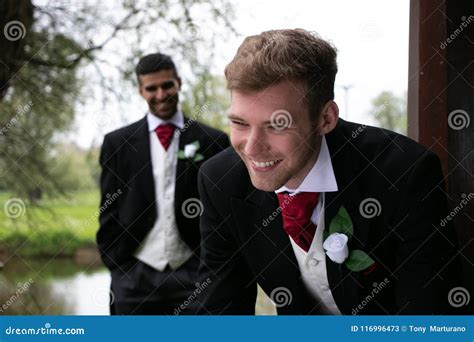Gay Couple Of Grooms Pose For Photographs By A Lake On Their Wedding Day Stock Image Image Of