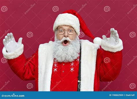 Amazed Shocked Funny Santa Claus Wearing Costume Isolated On Red