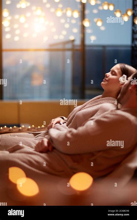 Young Attractive Woman And Man Lying On Massage Beds In Spa Center And