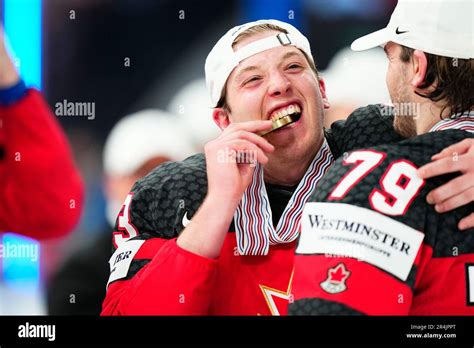 Canada S Jake Neighbours Bites His Gold Medal During A Ceremony