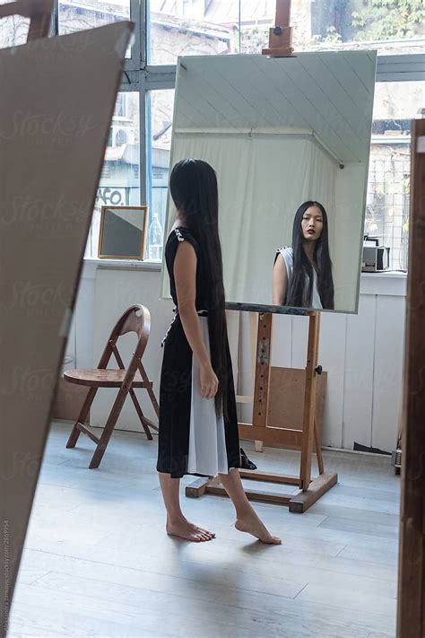 Beautiful Asian Woman Looking Herself In The Mirror By Stocksy