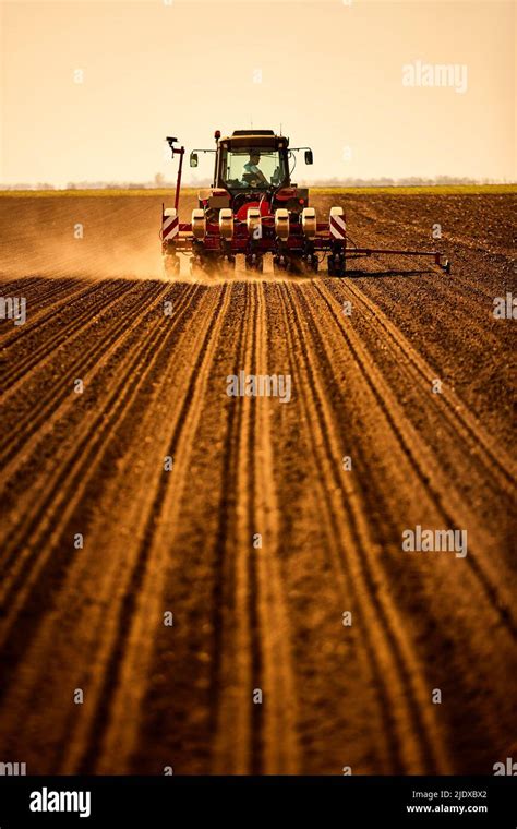 Farmer In Tractor Seeding Soybean Crops At Field Stock Photo Alamy