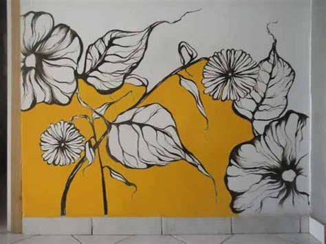 A Yellow And White Wall With Flowers Painted On The Wall Next To Tile