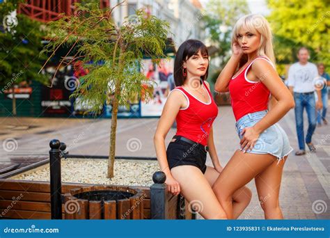 Two Beautiful Women Standing On The Street In Shorts Stock Image