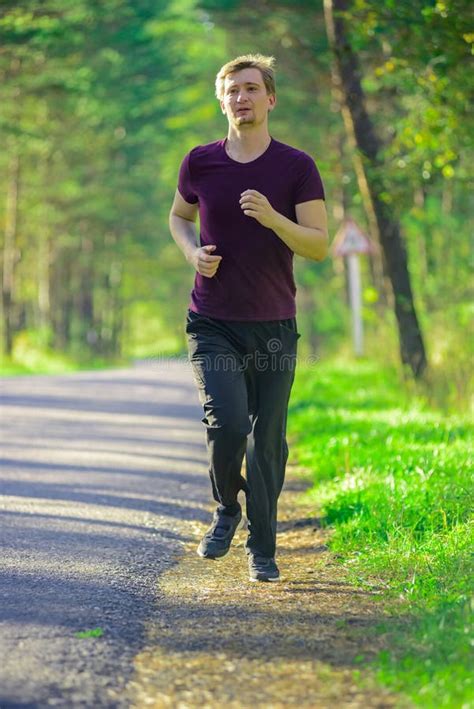 Man Jogging In City Partk At Beautiful Summer Day Sport Fitness Model