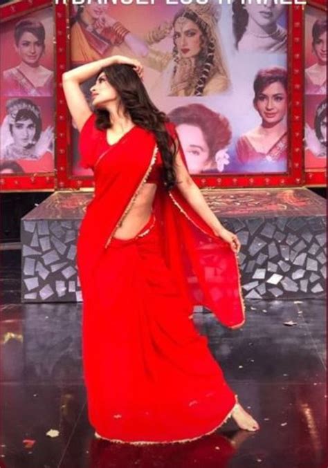 Mouni Roy Sizzles In Red Saree As She Poses On The Sets Of A Reality Show