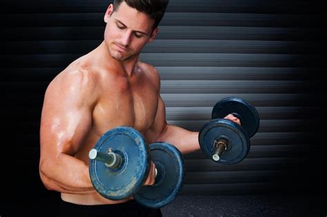 Premium Photo Bodybuilder Lifting Dumbbell Against Black Background