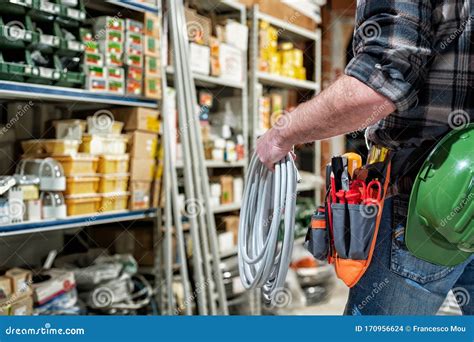 Electrician in the Store of Electrical Components. Electricity Stock ...