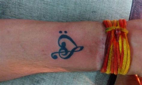 Heart and music symbol tattoo