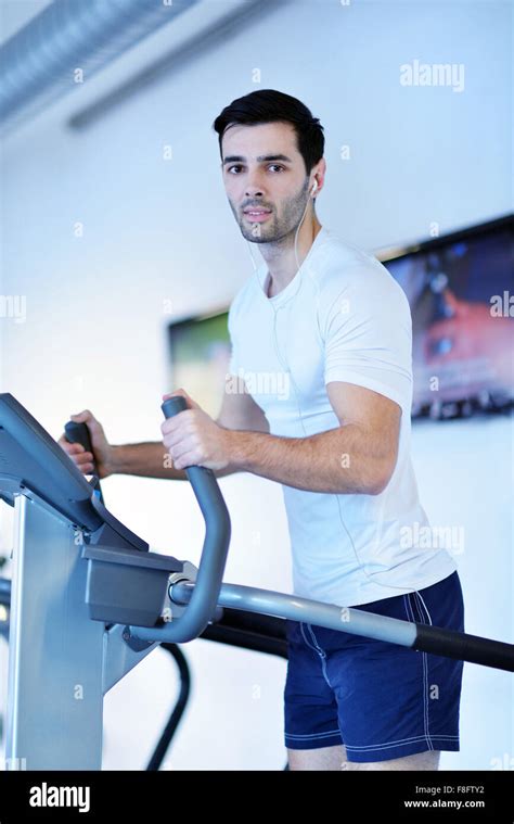 Handsome Man Running On The Treadmill In Modern Gym Stock Photo Alamy