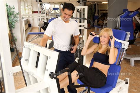 Attractive Blonde Woman And Her Trainer In A Gym Stock Photo Ikonoklast