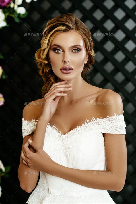 Beautiful Sexy Blonde Bride Posing In Wedding Dress On Wedding Flower Arch Stock Photo By Nikita