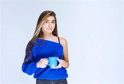 Fille Blonde Tenant Une Tasse De Café Bleu Photo Gratuite