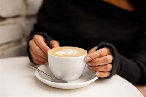Premium Photo Female Hand Hold Hot Coffee Cup