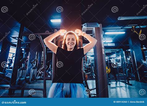 Sportive Woman Using Machine For Legs At The Gym Pretty Brunette Exercising In A Simulator