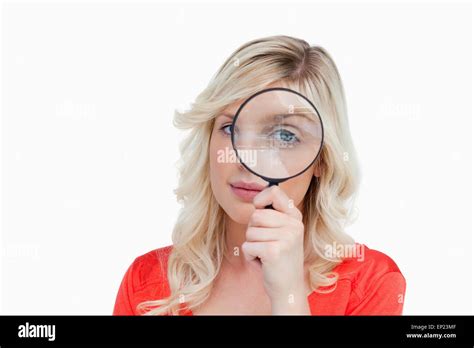 Fair Haired Woman Looking Through A Magnifying Glass Stock Photo Alamy