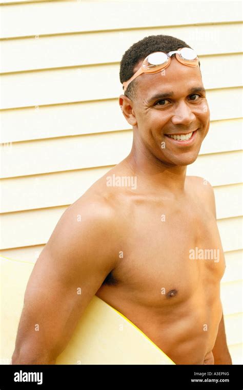 Portrait Of A Mature Man Carrying A Surfboard And Smiling Stock Photo Alamy