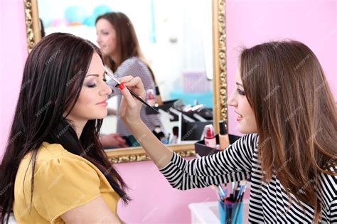 Premium Photo Young Woman Stylist Doing Makeup Beautiful Girl In