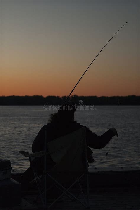 Fisherman on a Dock a Sunset Stock Photo - Image of orange, backlighting: 148017092