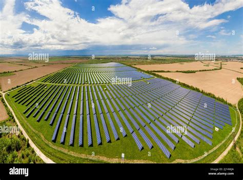 Aerial View Of Big Sustainable Electric Power Plant With Many Rows Of Solar Photovoltaic Panels