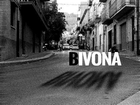 black and white photograph of street with buildings in the background ...