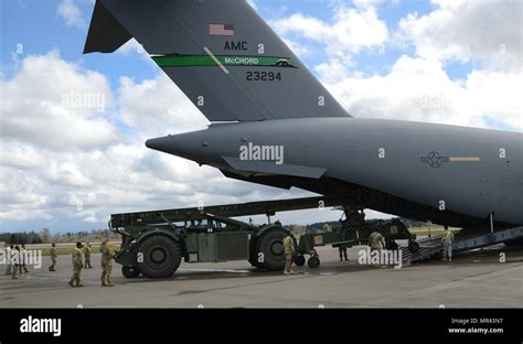 Airmen And Soldiers Load A Rough Terrain Container Handler Onto A C 17