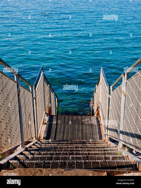 Trieste, Italy, stair to the blue sea waters on the rocky coast of ...