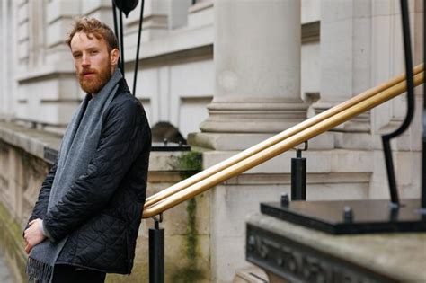 Premium Photo Bearded Hipster Leans Against A Railing In The Middle