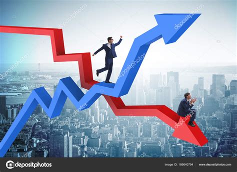 Businessman With Charts Of Growth And Decline Stock Photo Elnur