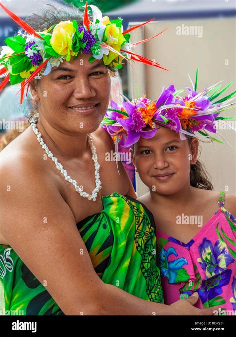 Mother And Daughter Dressed In Traditional Clothing With Floral