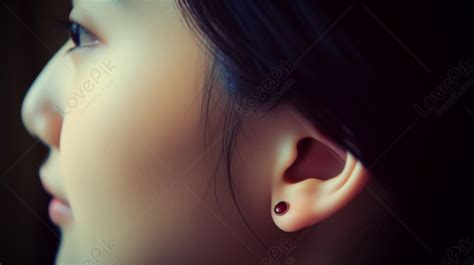 Image Of A Girls Ear Piercing And Hair Showing Up On The Side Of Her