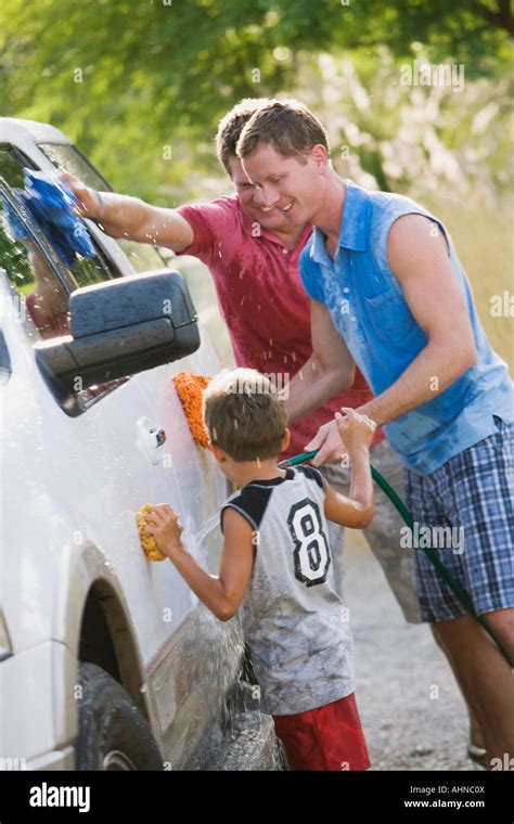 Gay Couple Washing The Car With Their Son Stock Photo Alamy