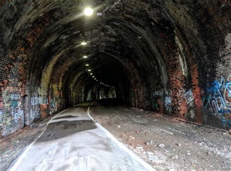 An Old Tunnel With Graffiti All Over It