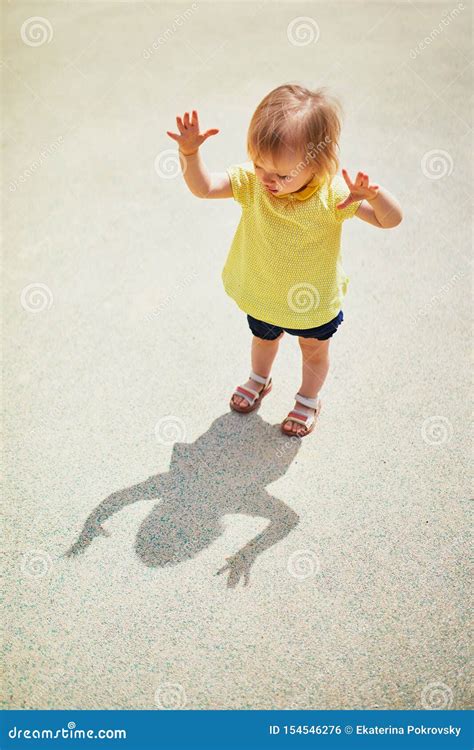 Adorable Toddler Girl Playing With Her Shadow Stock Photo Image Of