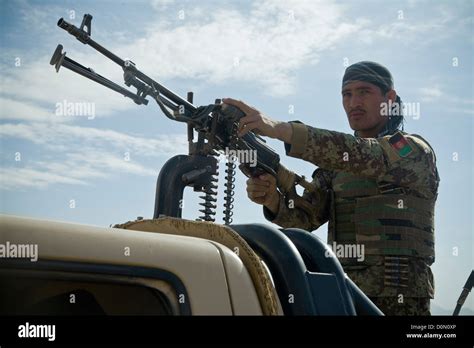 An Afghan National Army Soldier Maintains Security During Village